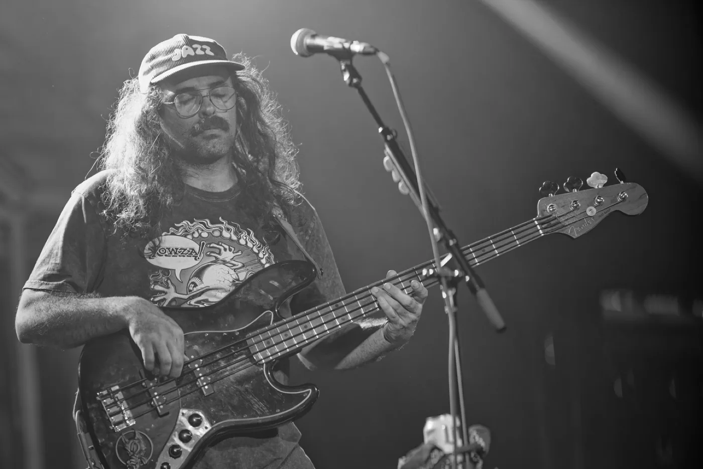 Playing bass on stage, in black and white